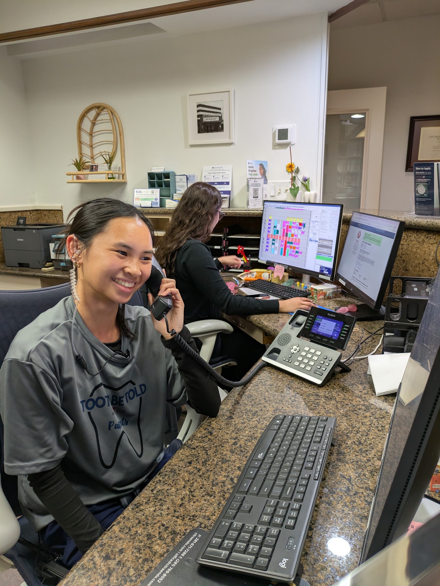 A member of the front desk on the phone