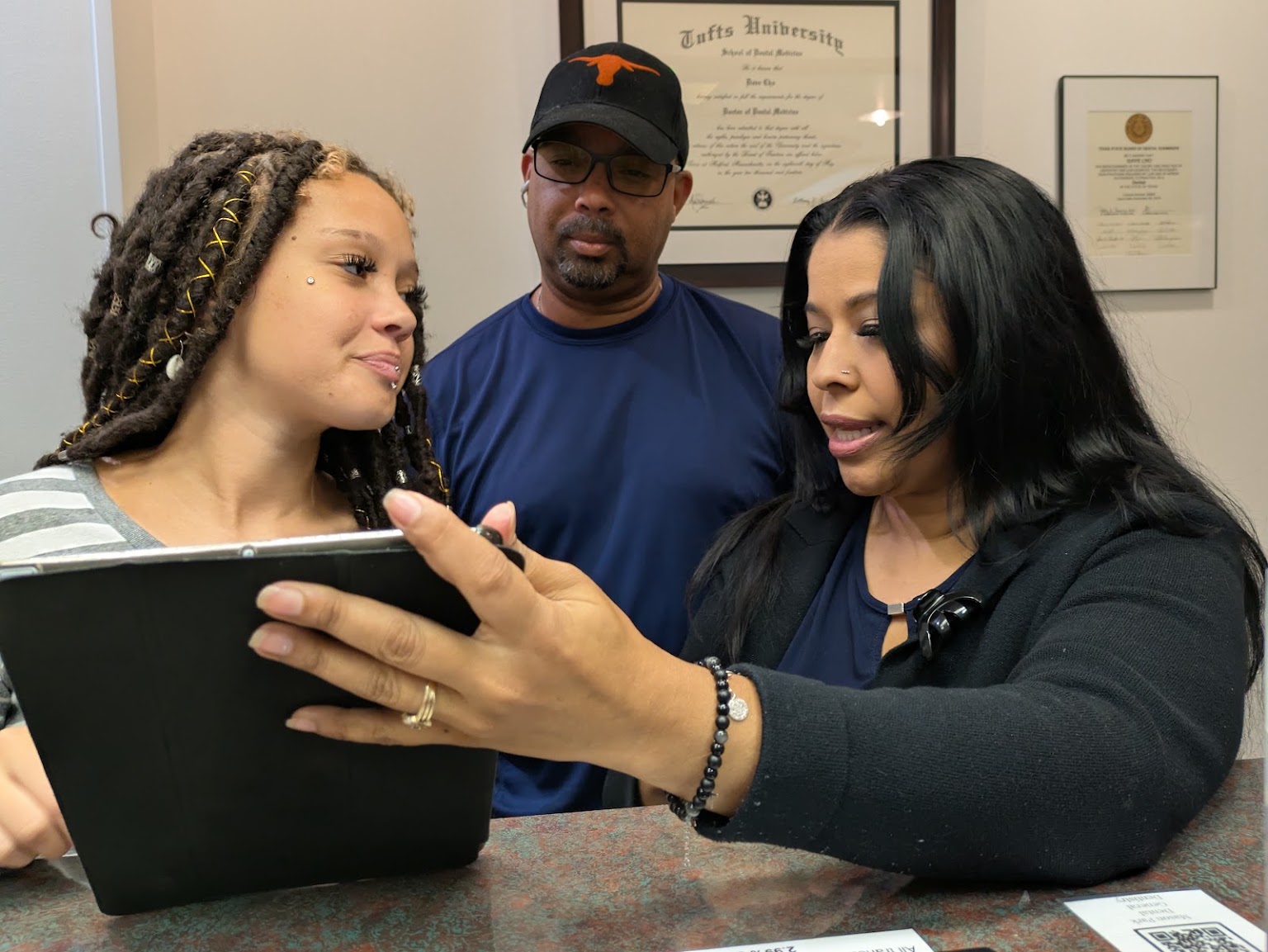 A family reviewing a treatment plan together at the front desk