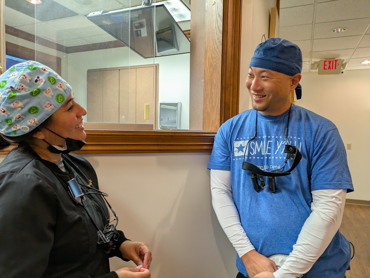 Two of the clinical team by the treatment room window