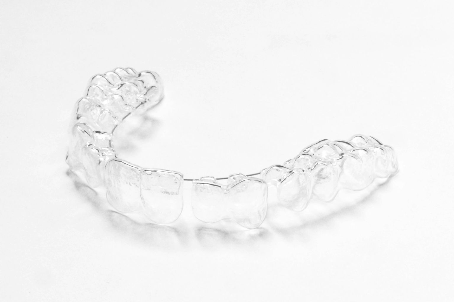 A clear night guard on a white surface