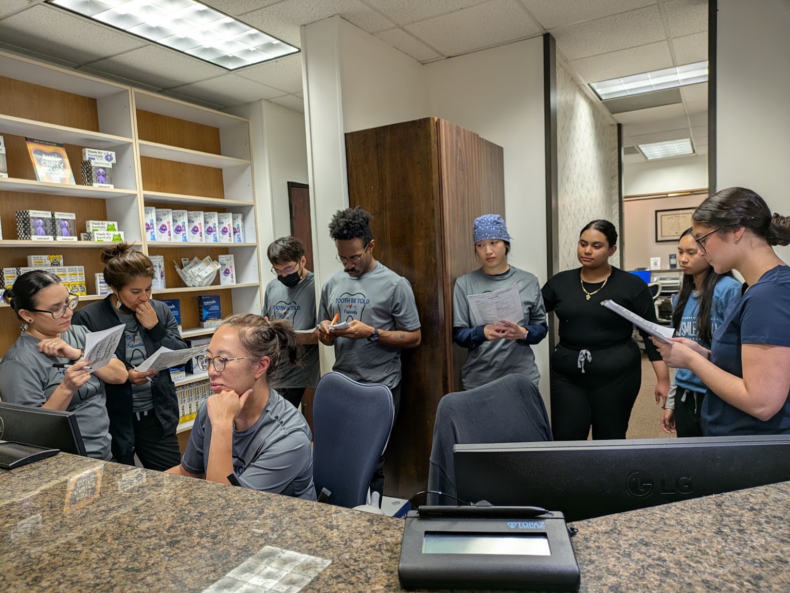 The Mason Park Dental team gathered at the front desk