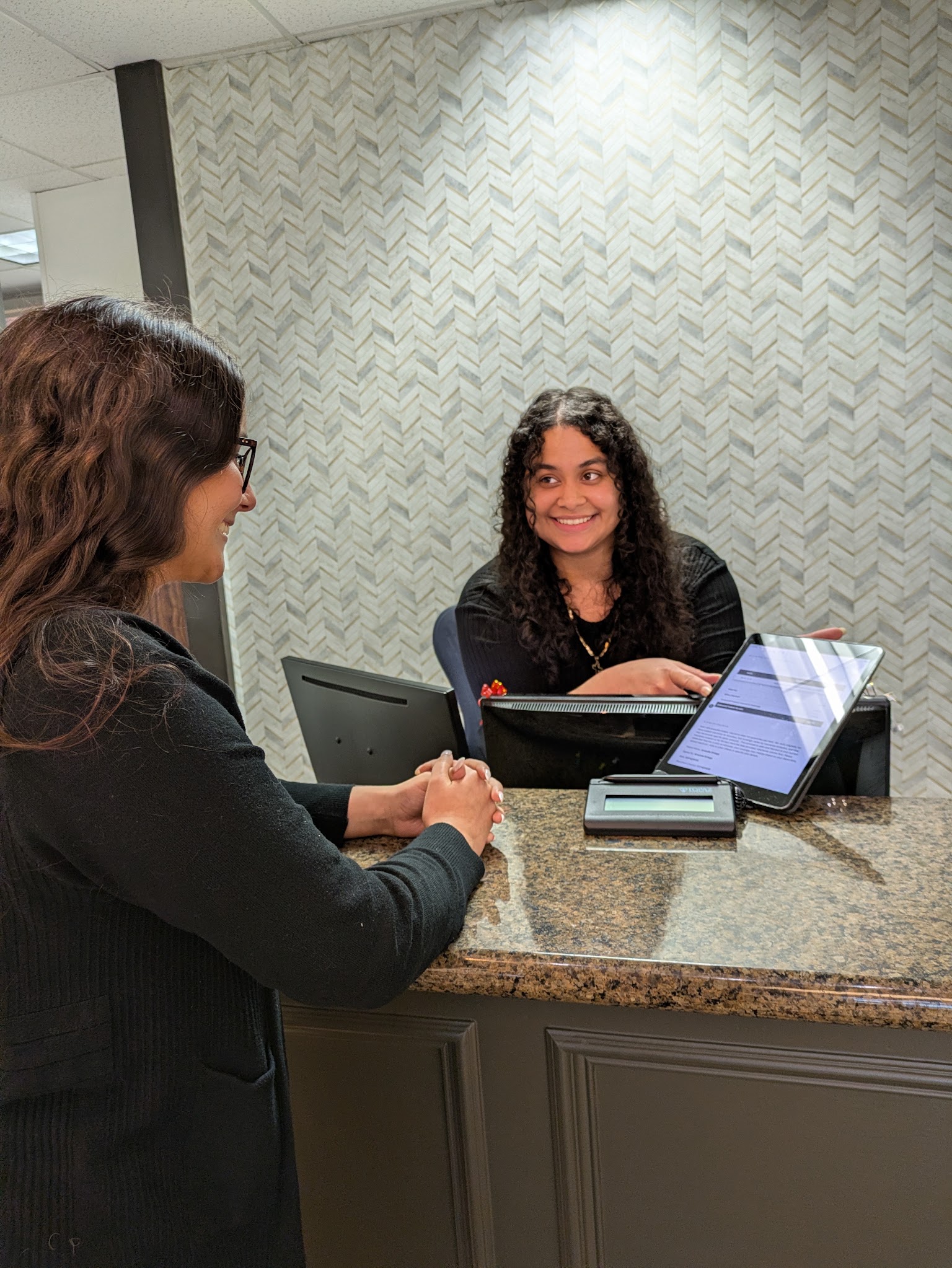 A patient talking with the front desk